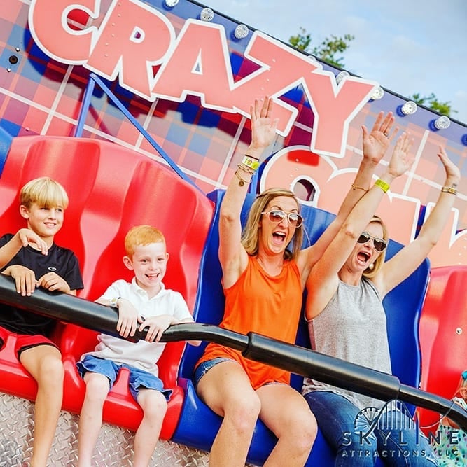 People laughing and riding a roller coaster