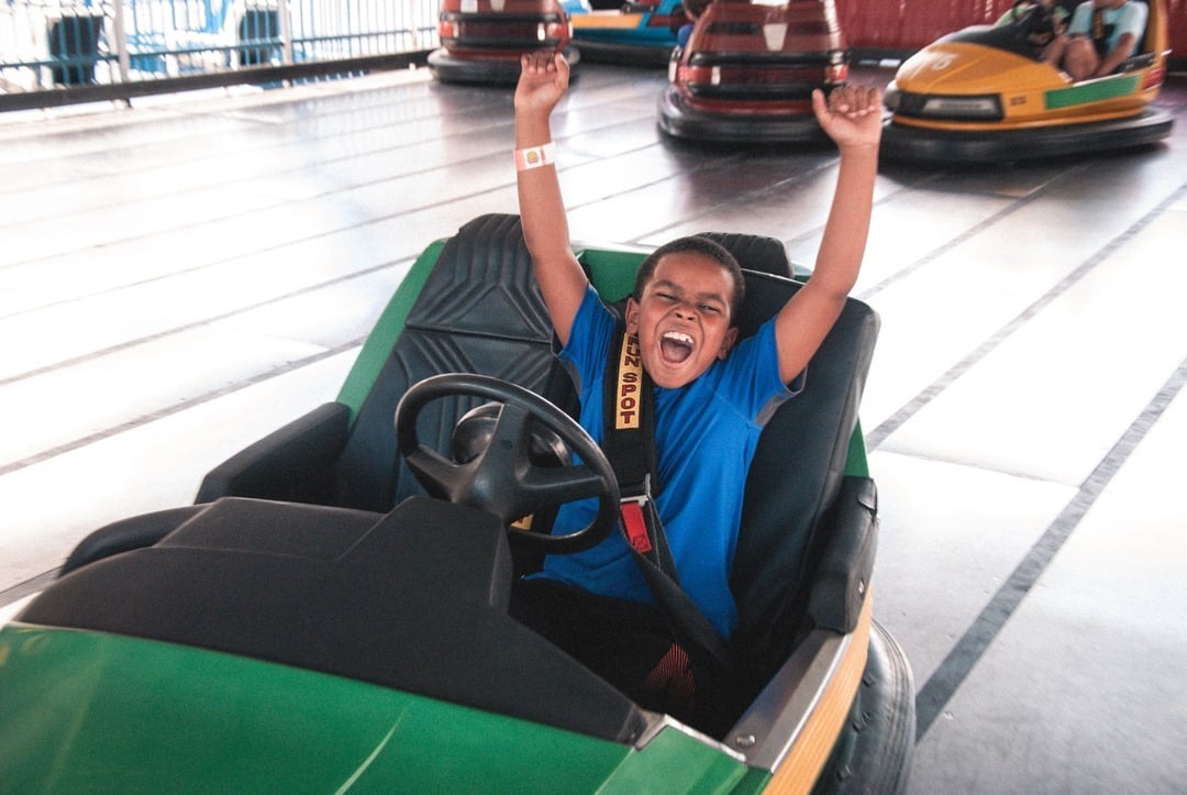 Happy boy driving a bumper car