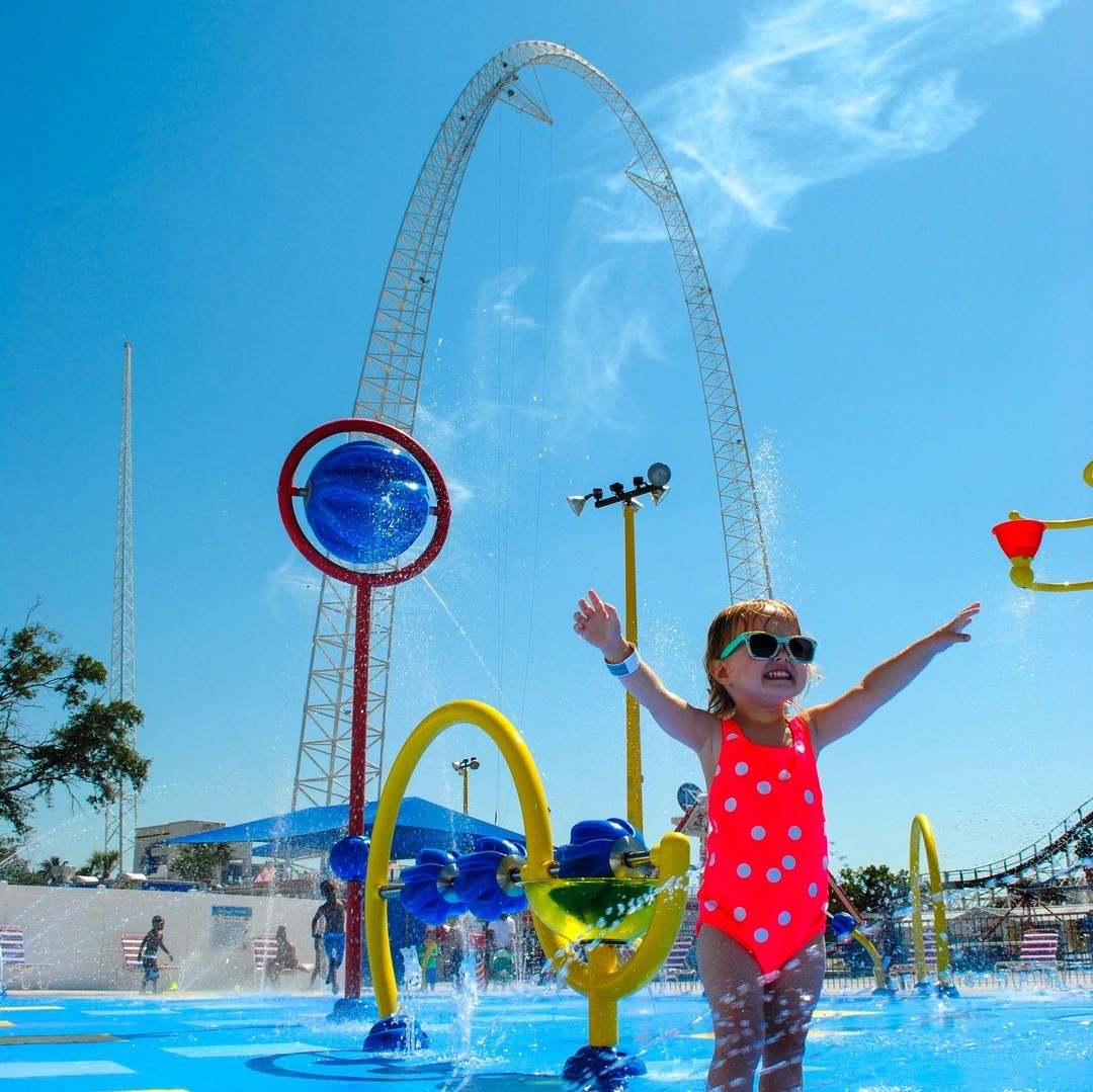 Young toddler in a bathing suit playing in the water