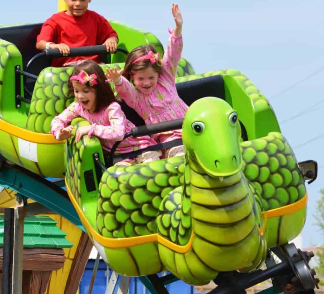 Excited twin girls riding the Sea Serpent roller coaster
