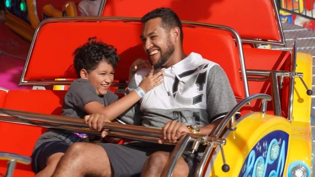 Father and child riding the Rock n Roll thrill ride