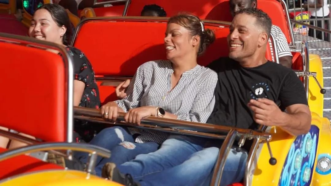 Smiling couple riding the Rock n Roll thrill ride