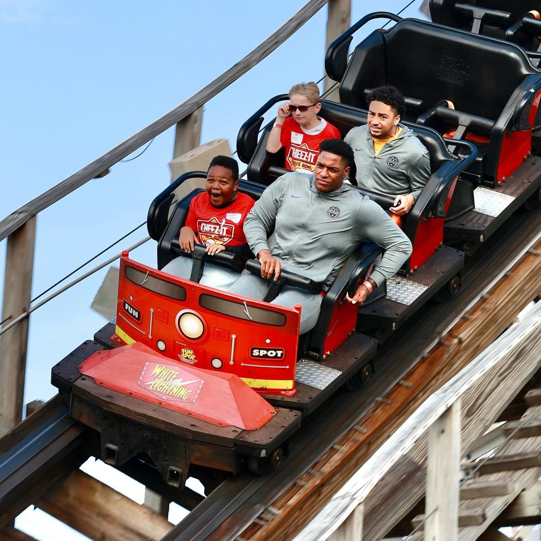 Park guests riding the White Lightning roller coaster