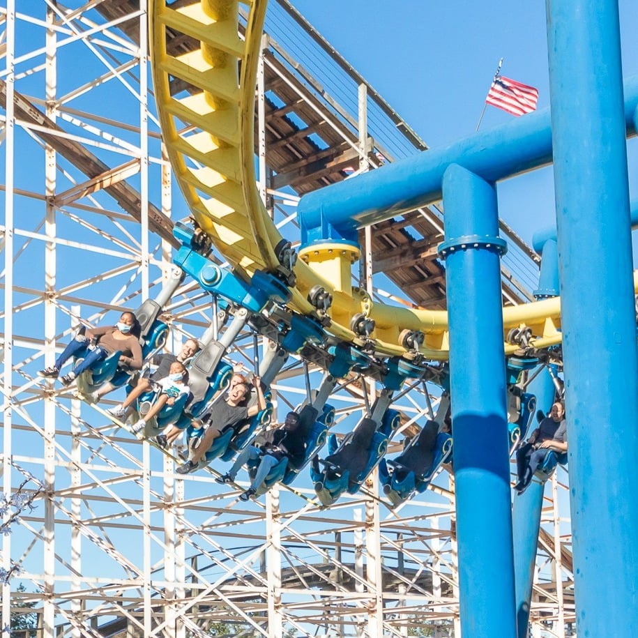 Park guests riding the Freedom Flyer roller coaster