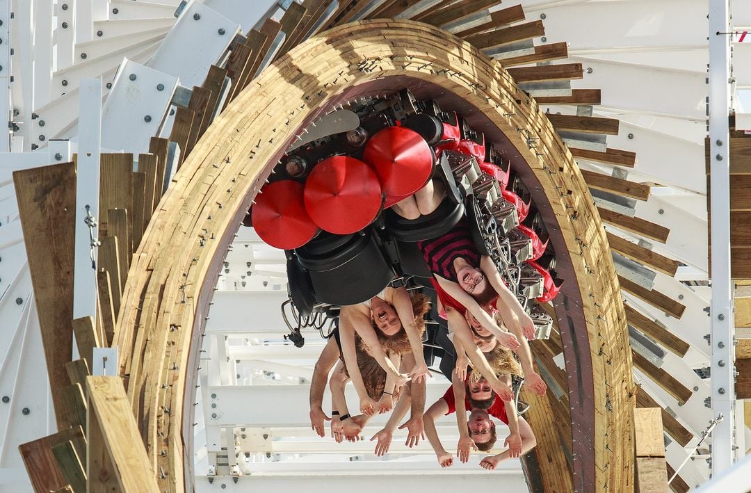 Park guests riding the Mine Blower roller coaster