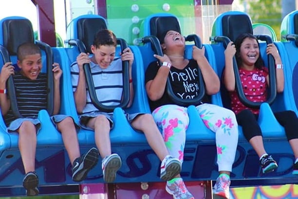 Laughing children riding the Screamer thrill ride
