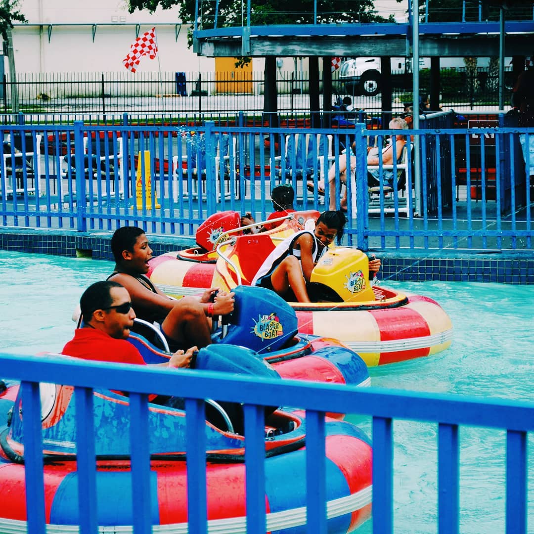 Laughing family riding bumper boats