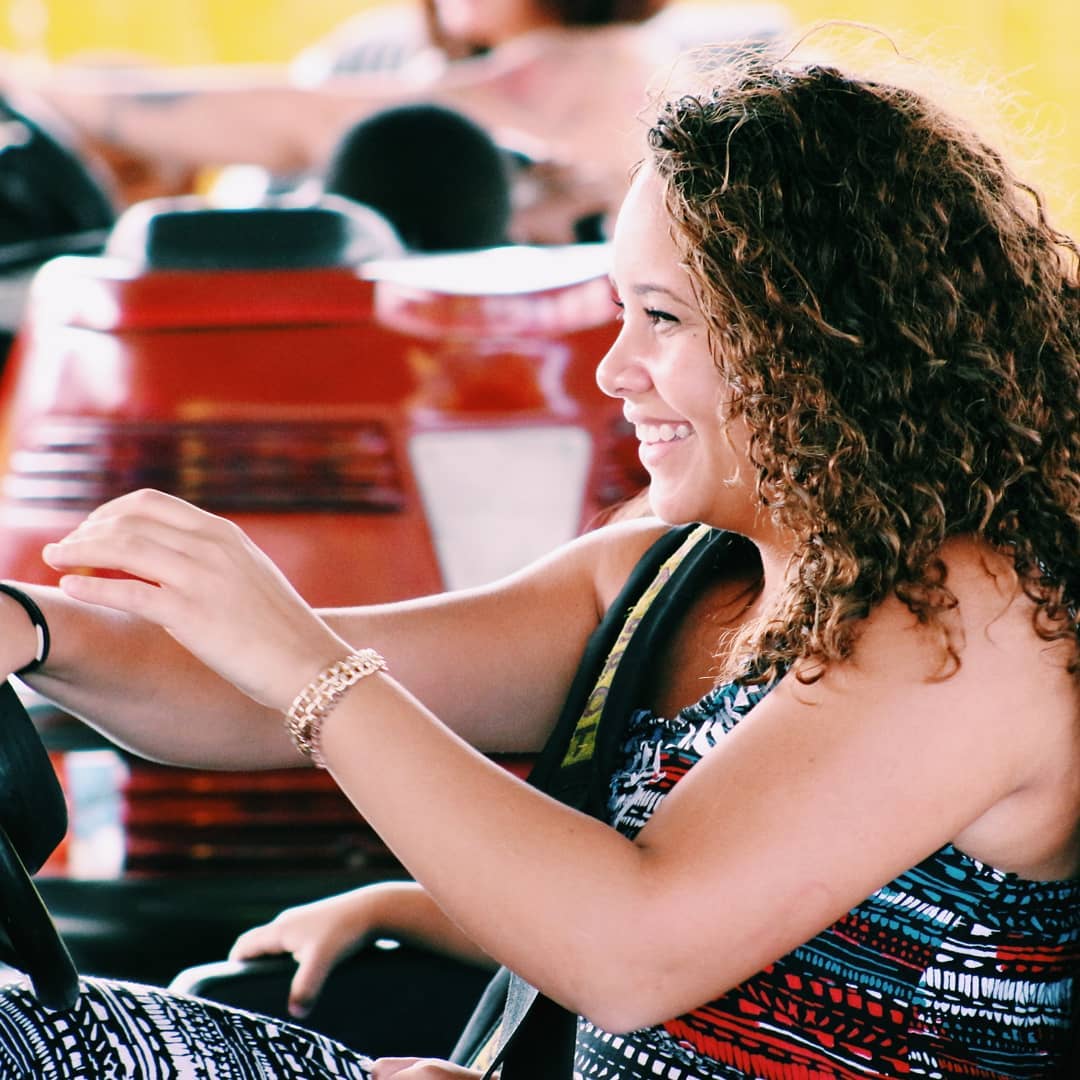 Smiling young woman riding in a bumper car